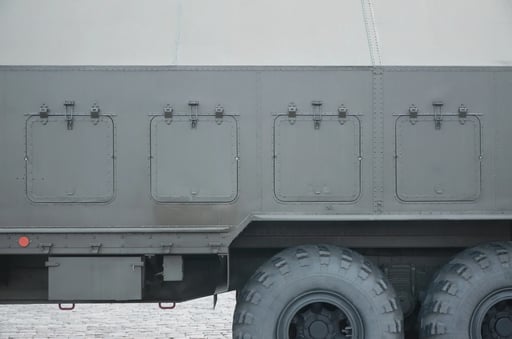 close-up-of-green-military-truck-modern-military-2023-11-27-04-58-16-utc