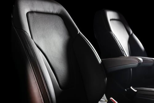 Close up of interior of car with comfortable perforated leather seats
