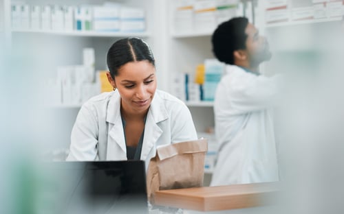 Medical worker in pharmacy with medications